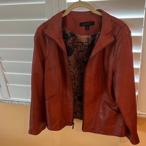 Leather jacket . Front zipper and on sleeves . Rust colored NOT Orange